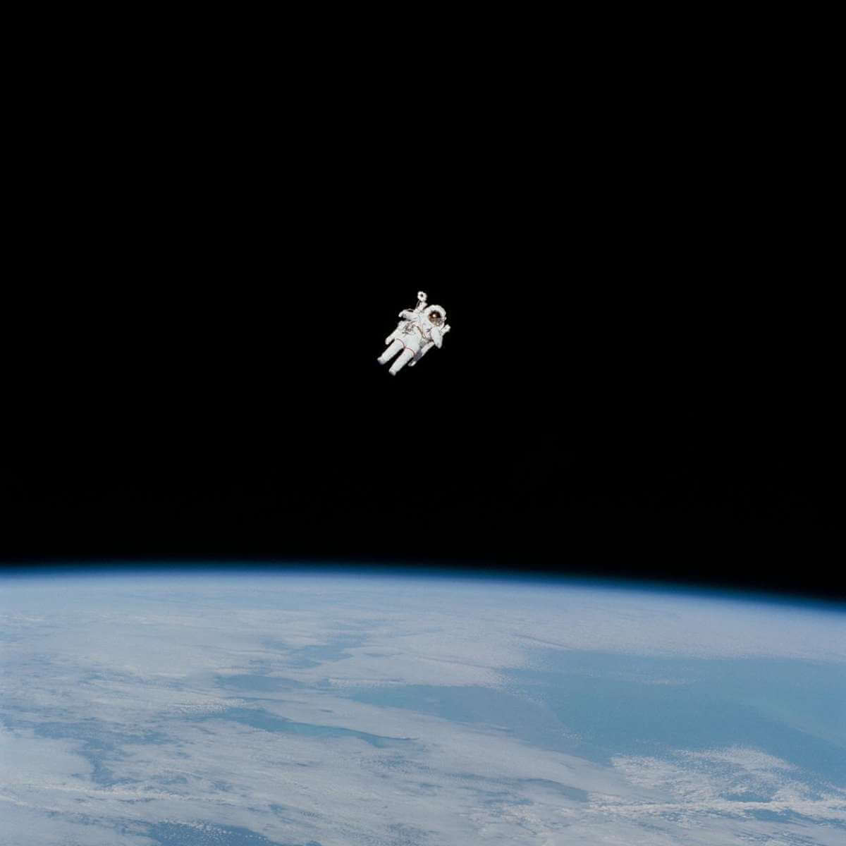 Astronaut Bruce McCandless II approaches his maximum distance from the Earth-orbiting Space Shuttle Challenger