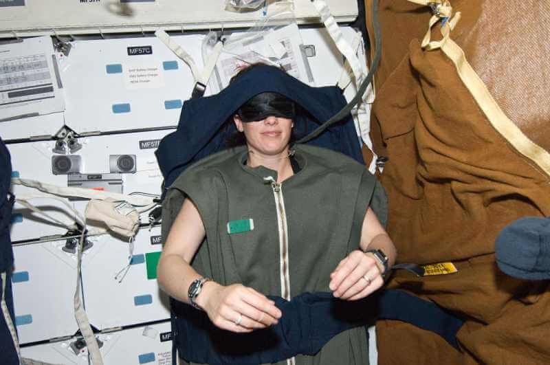 Astronaut using a sleeping bag