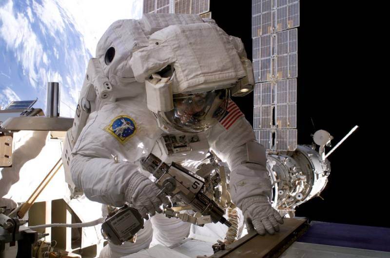 Astronaut using the pistol grip tool (PGT)