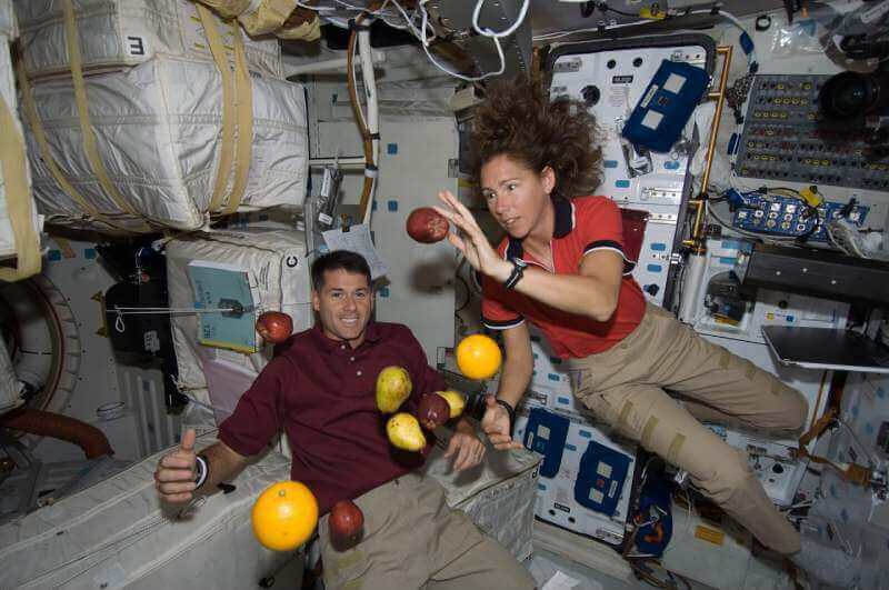 Astronauts Shane Kimbrough and Sandra Magnus are pictured with fresh fruit floating free